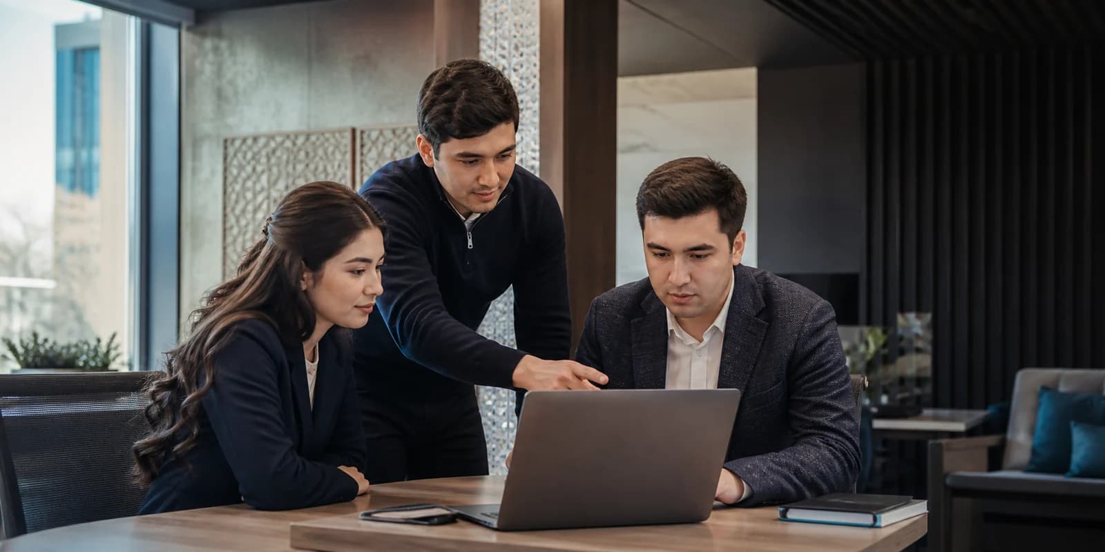 A customer operations team reviewing customer work together